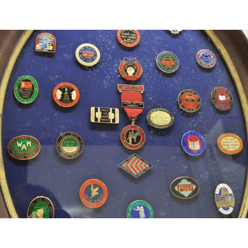 86 - Social History related pin badges displayed in oval glazed frame