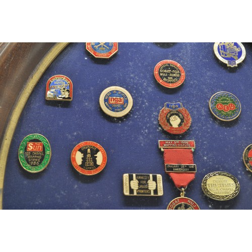 86 - Social History related pin badges displayed in oval glazed frame