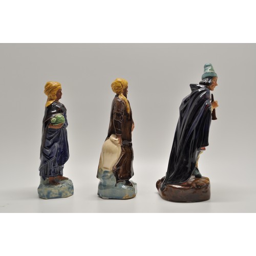 145 - In the style of Royal Doulton,  glazed Moorish and pied piper figures (x3 items) A/F