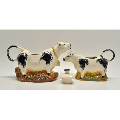 150 - Moorland Staffordshire Milk Jugs in the form of a Cow. Jug depicts a cow with the handle being the t... 