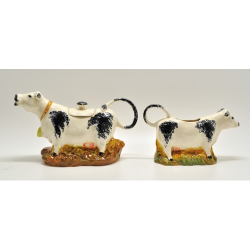 150 - Moorland Staffordshire Milk Jugs in the form of a Cow. Jug depicts a cow with the handle being the t... 