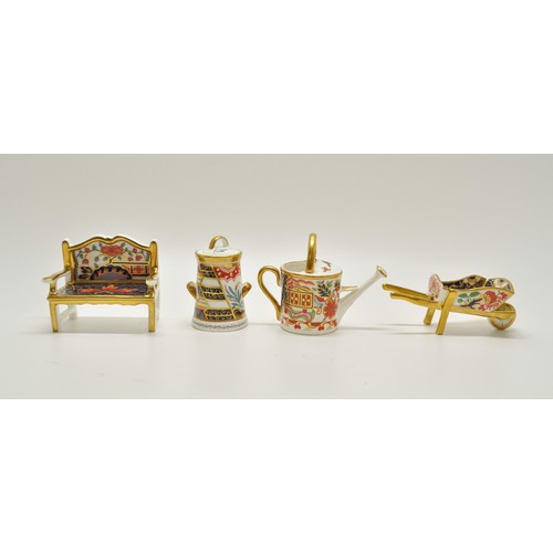 43 - Royal Crown Derby collection consisting of garden bench, wheelbarrow, watering can and tree of life,... 