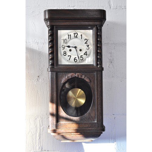 103 - Oak cased wall clock with a striking regulator, with a twisted column design to oak case top panel w... 