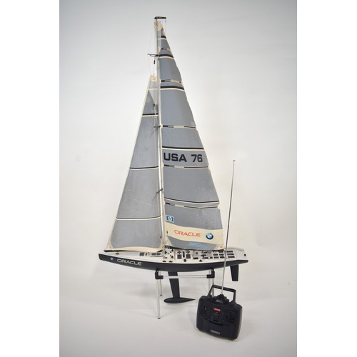 164 - A Scale Model Of The Oracle Racing Yacht, on stand and with a Kyosho Perfex controller