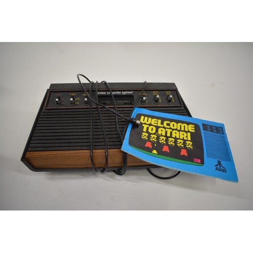 162 - Unboxed Atari video computer system console model CX-2600 with a selection of games to include Space... 