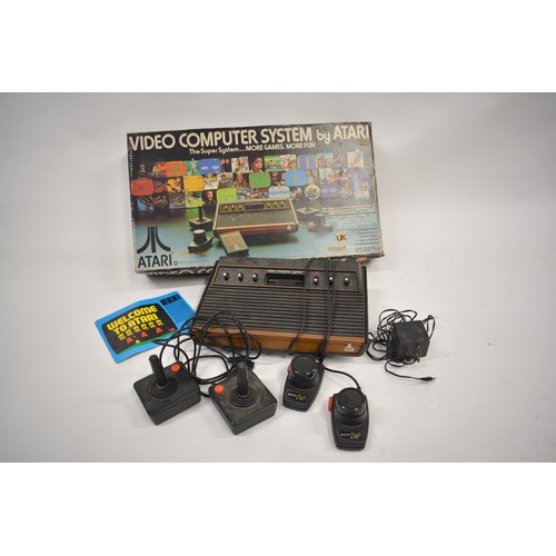 160 - Atari Video Computer System model CX-2600, with controllers, and games cartridges (no case)Pac Man, ... 