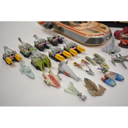 168 - Stars Wars Interest - A collection of Star Wars items to include pod racing figures, R2D2 micro mach... 