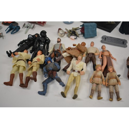 168 - Stars Wars Interest - A collection of Star Wars items to include pod racing figures, R2D2 micro mach... 