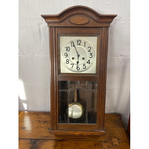 99 - Wald Gong cased wall clock with glazed lead effect panel with pendulum and key