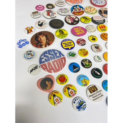 148 - A large collection of pin badges mixed themes to include pop, music, UK attractions,  merchandise ad... 