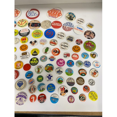 148 - A large collection of pin badges mixed themes to include pop, music, UK attractions,  merchandise ad... 