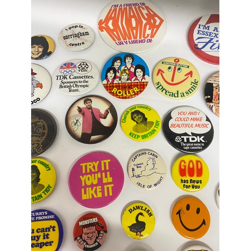 148 - A large collection of pin badges mixed themes to include pop, music, UK attractions,  merchandise ad... 