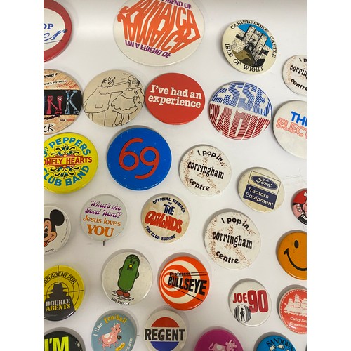 148 - A large collection of pin badges mixed themes to include pop, music, UK attractions,  merchandise ad... 