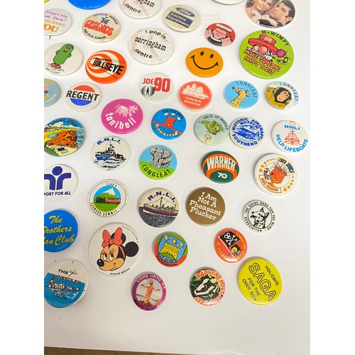 148 - A large collection of pin badges mixed themes to include pop, music, UK attractions,  merchandise ad... 