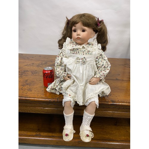 198 - Hand made Doll with a porcelain face and limbs, in seated pose