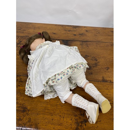 198 - Hand made Doll with a porcelain face and limbs, in seated pose