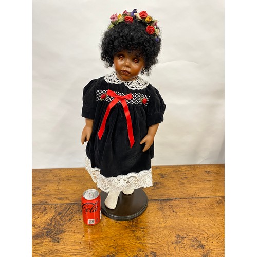 199 - Hand made doll with porcelain face and limbs, black tight curls, complete with stand/base, Approx H6... 