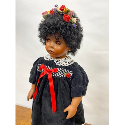 199 - Hand made doll with porcelain face and limbs, black tight curls, complete with stand/base, Approx H6... 