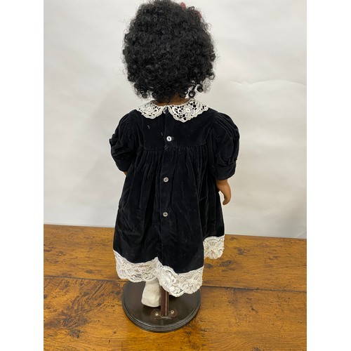 199 - Hand made doll with porcelain face and limbs, black tight curls, complete with stand/base, Approx H6... 