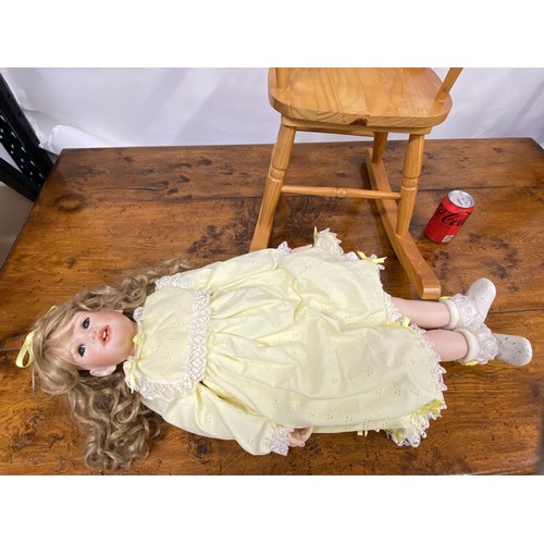 202 - Hand made doll with porcelain head and limbs, removable hair piece, also comes with wooden rocking c... 