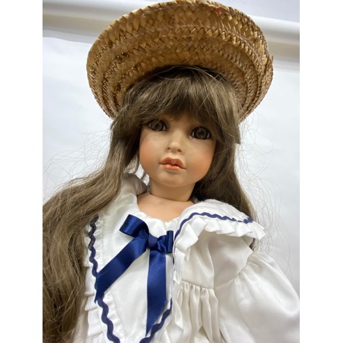 203 - Doll with porcelain head and limbs, with straw boater hat and removable stand, approx H74cm