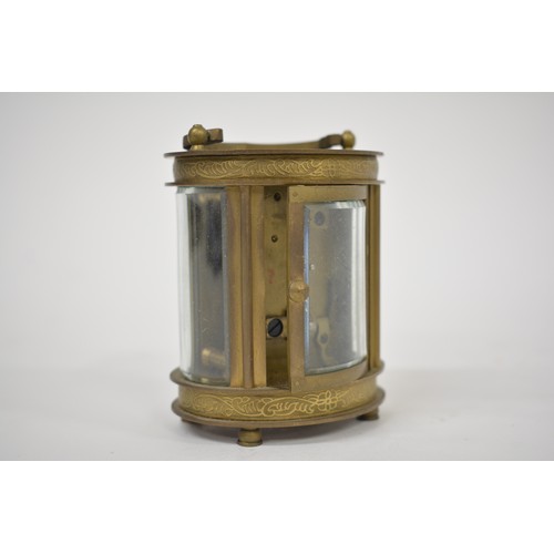 186 - Small French carriage clock retailed by Elliott & Son, London and contained in a glazed brass oval c... 