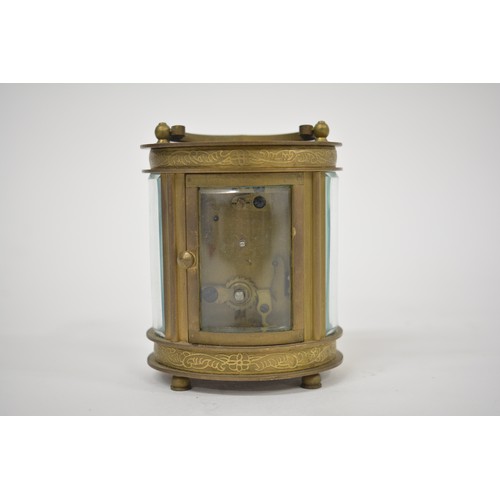 186 - Small French carriage clock retailed by Elliott & Son, London and contained in a glazed brass oval c... 