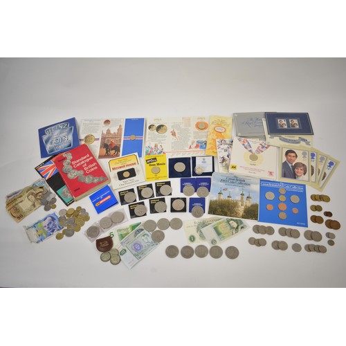 261 - A tin containing mixed coinage consisting of a silver proof Guernsey One Pound, uncirculated £2 and ... 