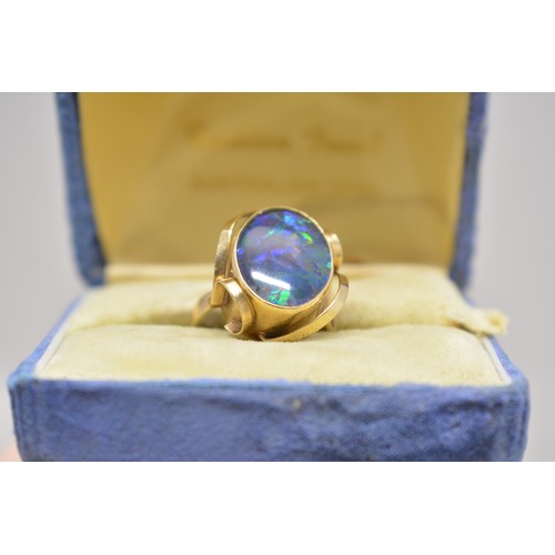 339 - 9ct gold ring stamped 9ct with scroll design to mount, central raised stone believed to be Australia... 