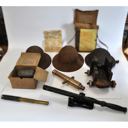 65 - Military-style steel helmets (x3), together with a small French telescope, ebonised truncheon in hol... 