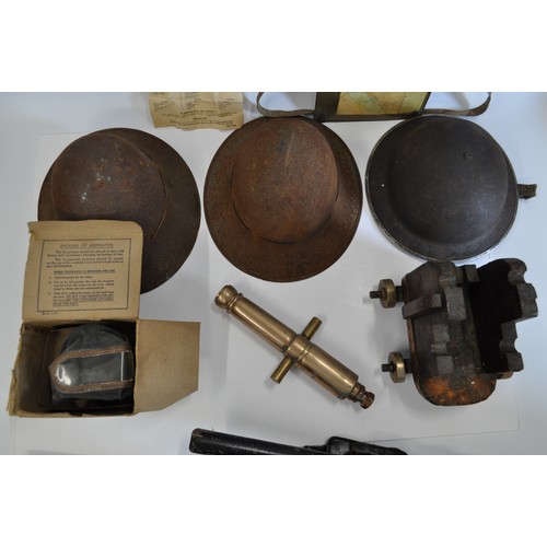 65 - Military-style steel helmets (x3), together with a small French telescope, ebonised truncheon in hol... 