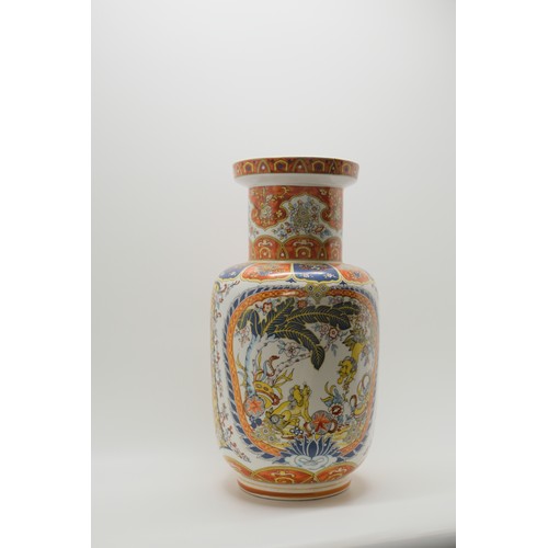 76 - Glazed Chinese vase with dancing foo dog design, mark EKEN to base. Approx H40cm