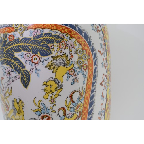 76 - Glazed Chinese vase with dancing foo dog design, mark EKEN to base. Approx H40cm