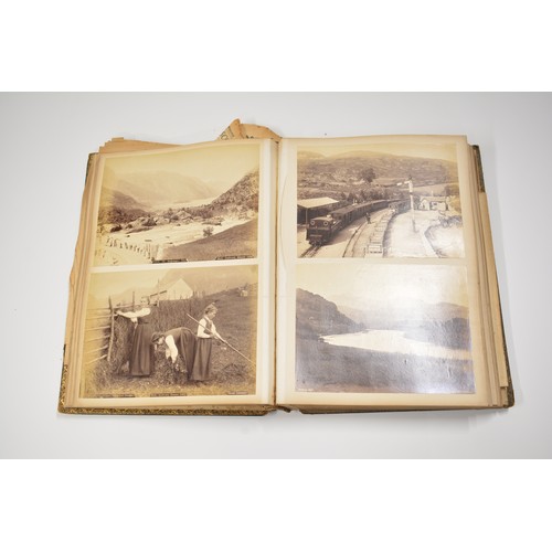 84 - Antique Victorian scrap album containing various photographs, newspaper clippings, and postcards wit... 