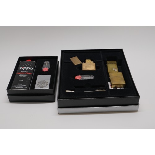 85 - Manchester United Zippo set together with three other brass Zippo lighters one marked with diagonal ... 