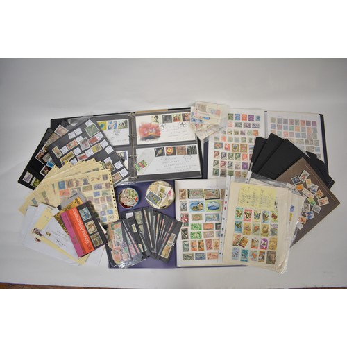 96 - Four stamp folders and a quantity of loose stamps from various countries plus a folder of first day ... 