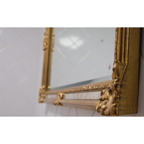 125 - Large rectangular gold coloured mirror with antique effect strip panel to outer design.