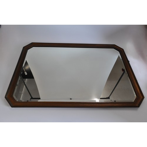 126 - Bevelled edge mirror with mahogony mount, Overall H 1M x W69cm.
Heavy item - Collection only