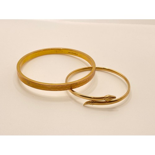 192 - 9ct gold bangle with decorative engraved design hallmarked Chester, 9.65g, together with one other 9... 