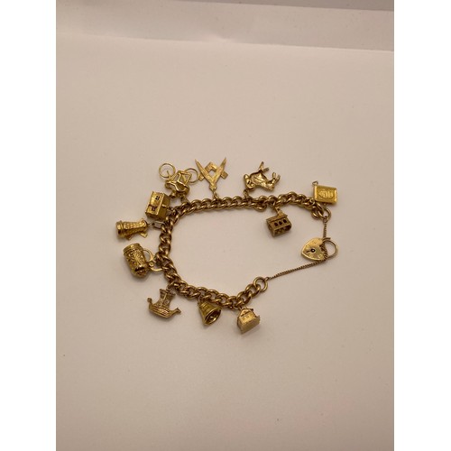 193 - Heavy Yellow gold link bracelet with x11 charms, approx gross weight 52g