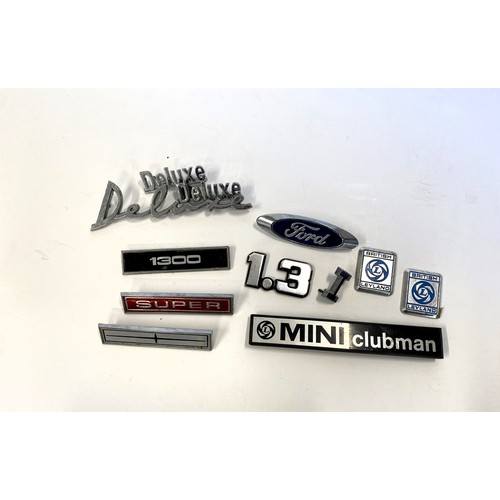 237 - A small group of car badges, Mini, Subaru, Ford, Etc.