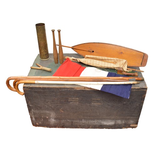 74 - Vintage trunk with contents to include pond yacht, french flag, trench art shell case, walking stick... 