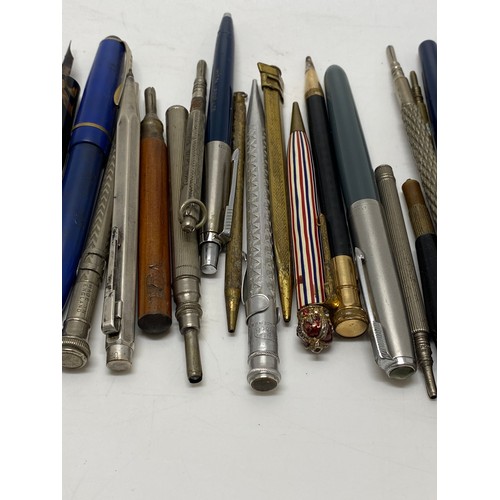 49 - A collection of fountain pens and pencils, including a Parker pen with 14k gold nib.