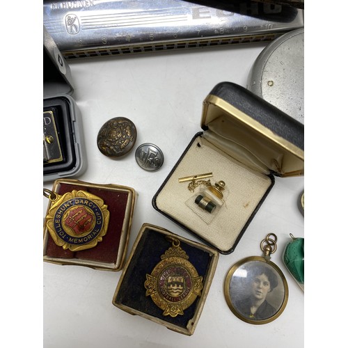 89 - Mixed ephemera consisting of badges, medallions, harmonica/mouth organs, hip flask, cufflinks, pen k... 