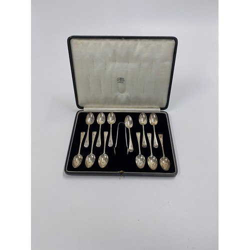 236 - A P Roger Cased set of x12 silver spoons with sugar tongs, decorative engraved flower design, MB mon... 