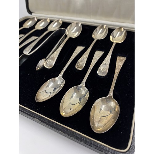 236 - A P Roger Cased set of x12 silver spoons with sugar tongs, decorative engraved flower design, MB mon... 