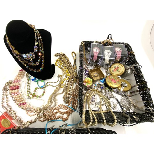 299 - A large quantity of mixed costume jewellery items including watches, compacts, necklaces, and some s... 