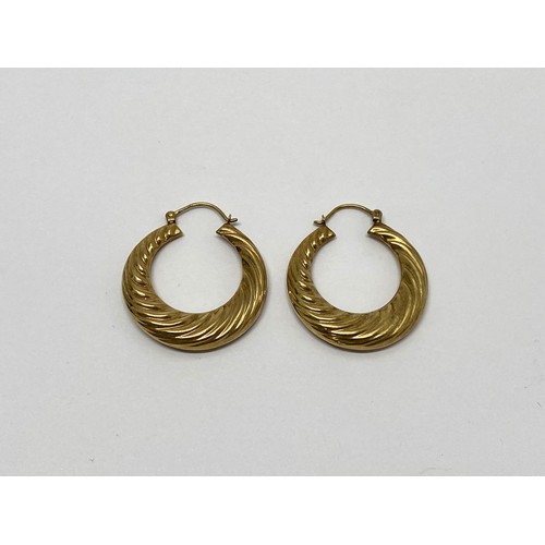 306 - A pair of yellow gold creole earrings stamped 375, weight 3.7 gms, overall length 38mm