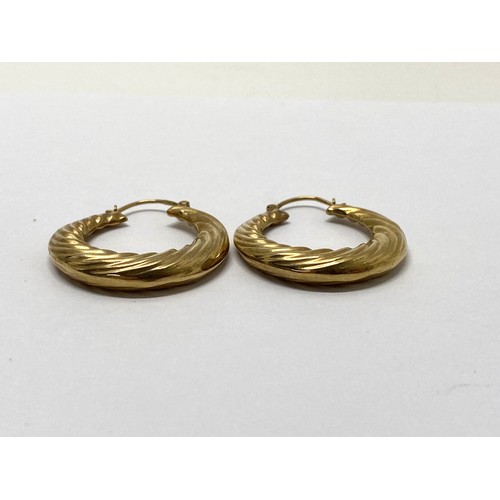 306 - A pair of yellow gold creole earrings stamped 375, weight 3.7 gms, overall length 38mm