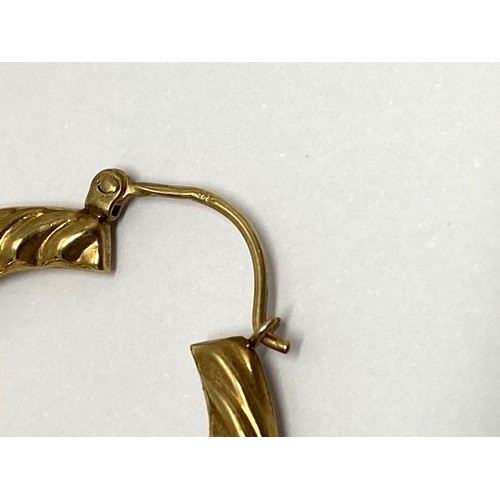 306 - A pair of yellow gold creole earrings stamped 375, weight 3.7 gms, overall length 38mm